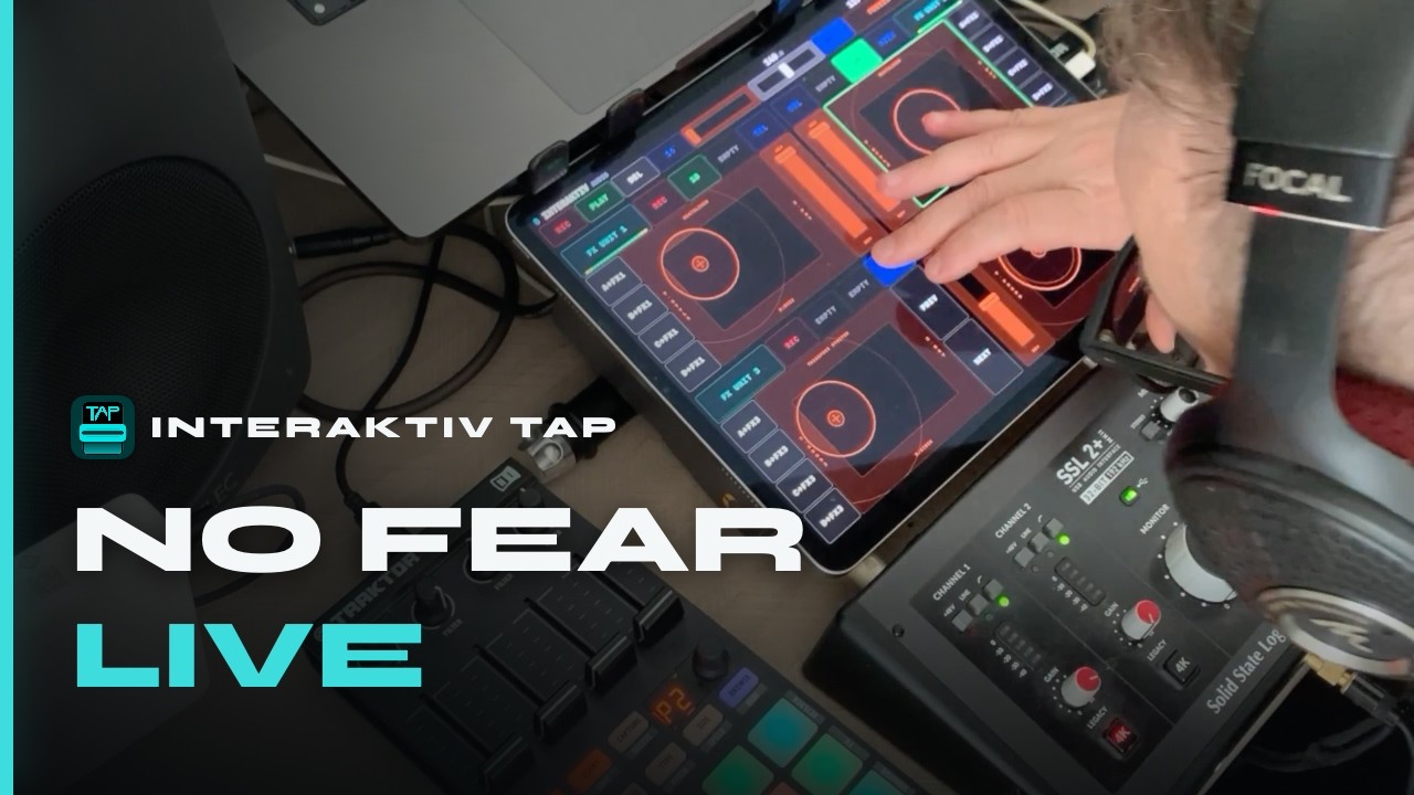 Interaktiv Tap on a stand mid-set — one hand on the surface, Kontrol X1 and audio interface below, laptop behind. Poster frame for the full live set video.